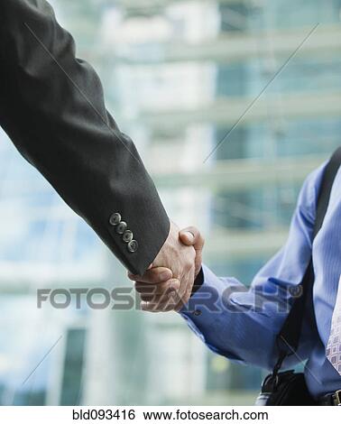 Stock Photograph - Businessmen shaking hands. Fotosearch