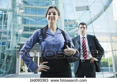Stock Image - Caucasian business people standing outdoors. Fotosearch