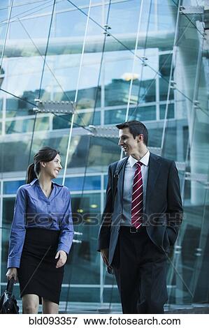 Stock Photo - Caucasian business people walking together outdoors. Fotosearch