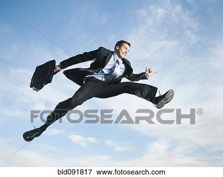 Caucasian businessman jumping in air View Large Photo Image Stock Photo - Caucasian businessman jumping in air. Fotosearch