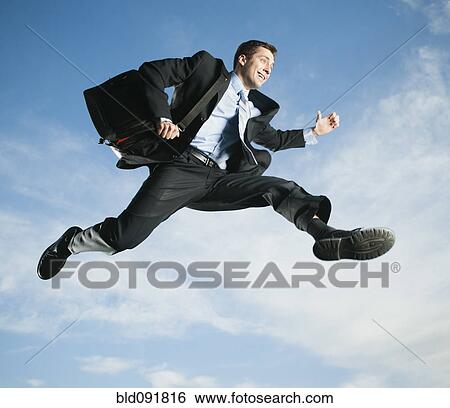 Stock Photograph - Caucasian businessman jumping in air. Fotosearch