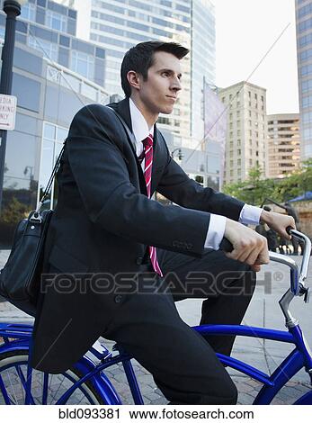 Caucasian businessman riding bicycle View Large Photo Image Stock Image - Caucasian businessman riding bicycle. Fotosearch