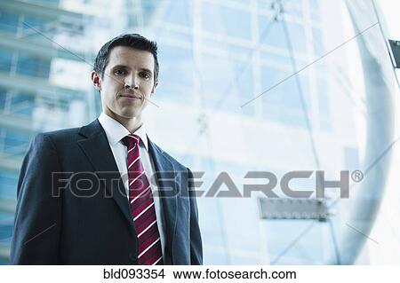 Picture - Caucasian businessman standing outdoors. Fotosearch