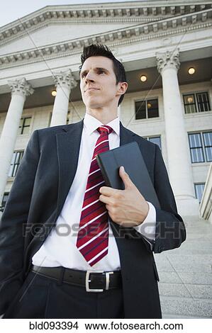 Caucasian businessman standing outdoors View Large Photo Image Picture - Caucasian businessman standing outdoors. Fotosearch