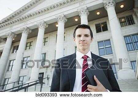 Stock Image - Caucasian businessman standing outdoors. Fotosearch