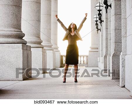 Caucasian businesswoman cheering outdoors with arms raised View Large Photo Image Stock Photo - Caucasian businesswoman cheering outdoors with arms raised. Fotosearch