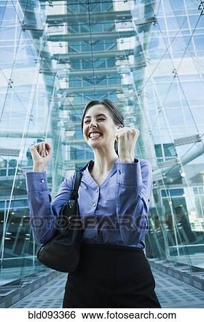 Stock Photograph - Caucasian businesswoman cheering outdoors. Fotosearch