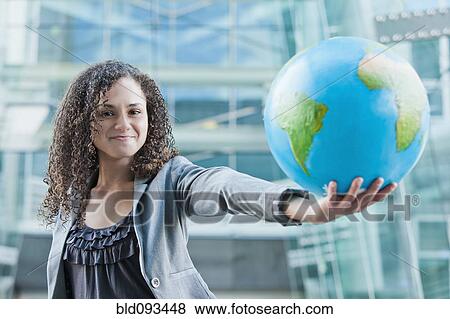Caucasian businesswoman holding globe View Large Photo Image Stock Photo - Caucasian businesswoman holding globe. Fotosearch