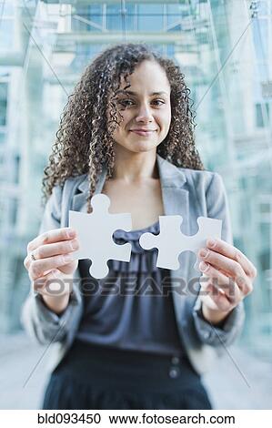 Caucasian businesswoman holding jigsaw puzzle pieces View Large Photo Image Stock Image - Caucasian businesswoman holding jigsaw puzzle pieces. Fotosearch