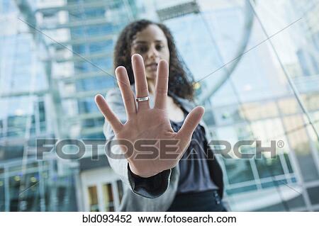 Stock Image - Caucasian businesswoman holding out hand. Fotosearch