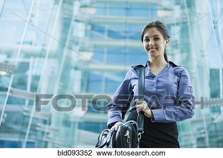 Caucasian businesswoman holding briefcase outdoors View Large Photo Image Stock Image - Caucasian businesswoman holding briefcase outdoors. Fotosearch