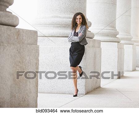 Caucasian businesswoman leaning against pillar outdoors View Large Photo Image Picture - Caucasian businesswoman leaning against pillar outdoors. Fotosearch
