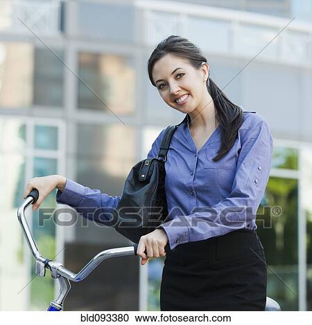 Caucasian businesswoman riding bicycle View Large Photo Image Stock Image - Caucasian businesswoman riding bicycle. Fotosearch