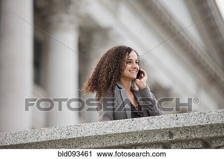 Caucasian businesswoman talking on cell phone outdoors View Large Photo Image Stock Image - Caucasian businesswoman talking on cell phone outdoors. Fotosearch