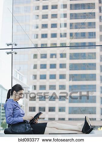 Stock Photo - Caucasian businesswoman using digital tablet. Fotosearch