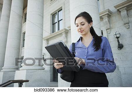 Caucasian businesswoman using digital tablet outdoors View Large Photo Image Stock Photograph - Caucasian businesswoman using digital tablet outdoors. Fotosearch