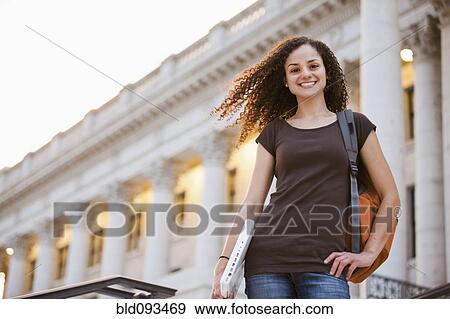 Stock Photo - Caucasian college student holding laptop outdoors. Fotosearch