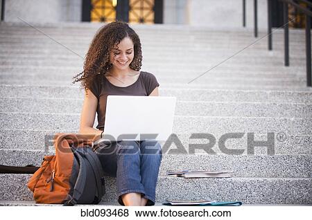 Caucasian college student using laptop outdoors View Large Photo Image Stock Photo - Caucasian college student using laptop outdoors. Fotosearch