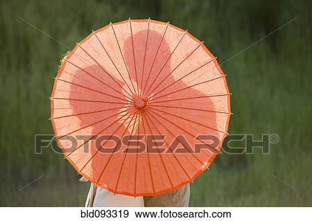 Caucasian couple standing behind parasol View Large Photo Image Stock Photo - Caucasian couple standing behind parasol. Fotosearch