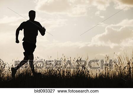 Caucasian man running at sunset View Large Photo Image Stock Photo - Caucasian man running at sunset. Fotosearch