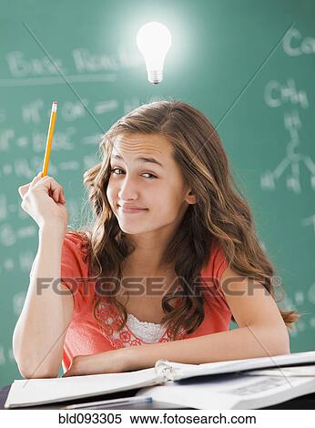 Caucasian student with light bulb over her head View Large Photo Image Stock Photography - Caucasian student with light bulb over her head. Fotosearch
