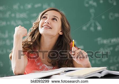 Stock Photo - Caucasian teenager daydreaming in classroom. Fotosearch