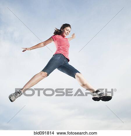 Caucasian teenager jumping in air View Large Photo Image Picture - Caucasian teenager jumping in air. Fotosearch