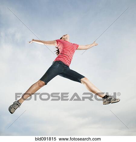 Stock Photography - Caucasian teenager jumping in air. Fotosearch