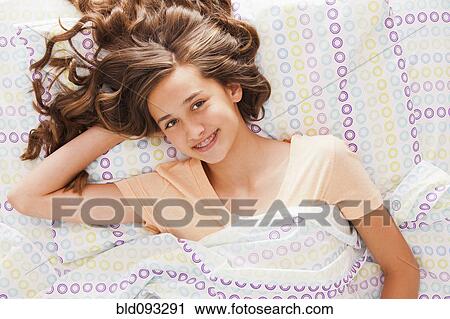 Caucasian teenager laying in bed View Large Photo Image Stock Image - Caucasian teenager laying in bed. Fotosearch