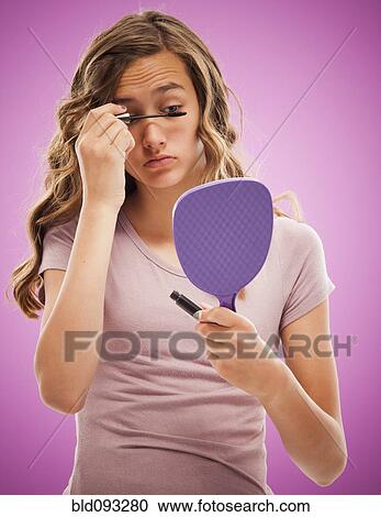 Caucasian teenager putting on mascara View Large Photo Image Stock Image - Caucasian teenager putting on mascara. Fotosearch