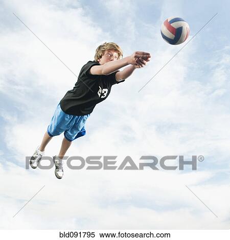Stock Photography - Caucasian teenager returning volleyball. Fotosearch