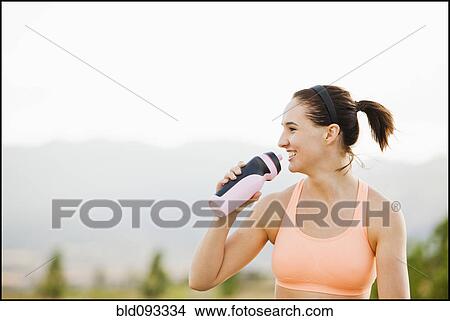 Caucasian woman drinking water after workout View Large Photo Image Picture - Caucasian woman drinking water after workout. Fotosearch