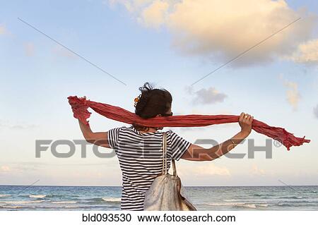 Stock Image - Caucasian woman enjoying beach. Fotosearch
