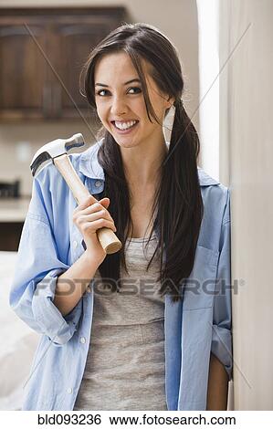 Caucasian woman holding hammer View Large Photo Image Stock Photograph - Caucasian woman holding hammer. Fotosearch