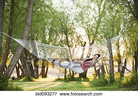 Caucasian woman laying in hammock View Large Photo Image Stock Photo - Caucasian woman laying in hammock. Fotosearch