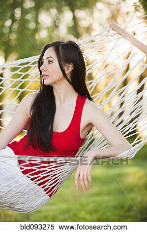 Stock Photography - Caucasian woman laying in hammock. Fotosearch