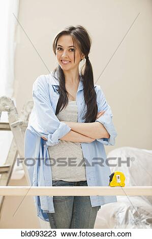 Caucasian woman measuring wood View Large Photo Image Stock Image - Caucasian woman measuring wood. Fotosearch
