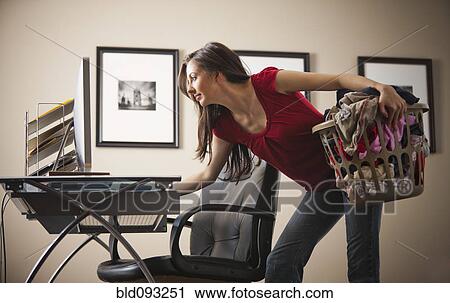 Stock Image - Caucasian woman multi-tasking home office. Fotosearch