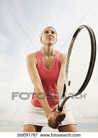 Stock Photo - Caucasian woman playing tennis. Fotosearch