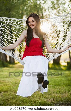 Caucasian woman sitting in hammock View Large Photo Image Stock Image - Caucasian woman sitting in hammock. Fotosearch