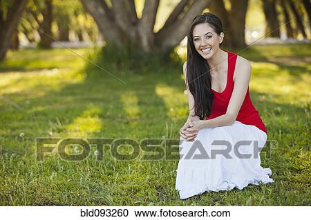 Caucasian woman squatting in grass View Large Photo Image Stock Image - Caucasian woman squatting in grass. Fotosearch