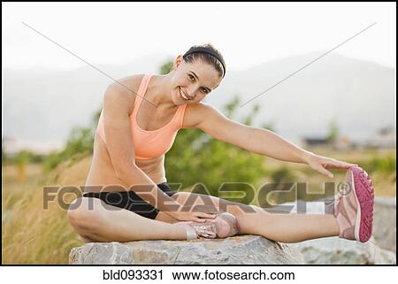 Caucasian woman stretching before workout View Large Photo Image Stock Image - Caucasian woman stretching before workout. Fotosearch