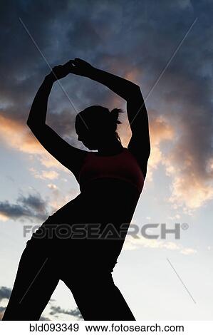 Caucasian woman stretching before exercise at sunset View Large Photo Image Stock Photo - Caucasian woman stretching before exercise at sunset. Fotosearch
