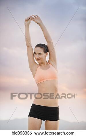 Caucasian woman stretching View Large Photo Image Stock Photography - Caucasian woman stretching. Fotosearch