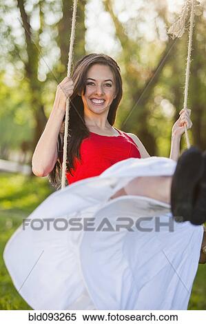 Caucasian woman swinging on swing View Large Photo Image Stock Photography - Caucasian woman swinging on swing. Fotosearch