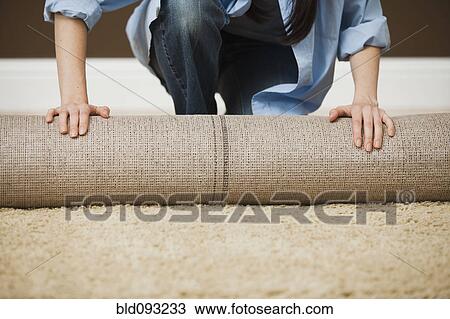 Caucasian woman unrolling carpet View Large Photo Image Stock Image - Caucasian woman unrolling carpet. Fotosearch