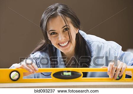 Caucasian woman using level View Large Photo Image Stock Photo - Caucasian woman using level. Fotosearch