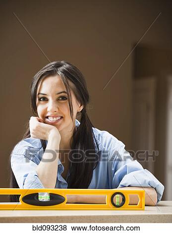 Stock Photo - Caucasian woman with level. Fotosearch