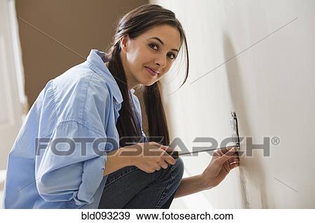 Caucasian woman working on electrical outlet View Large Photo Image Stock Photo - Caucasian woman working on electrical outlet. Fotosearch