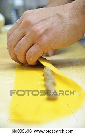 Stock Image - Chef rolling homemade agnolotti pasta. Fotosearch